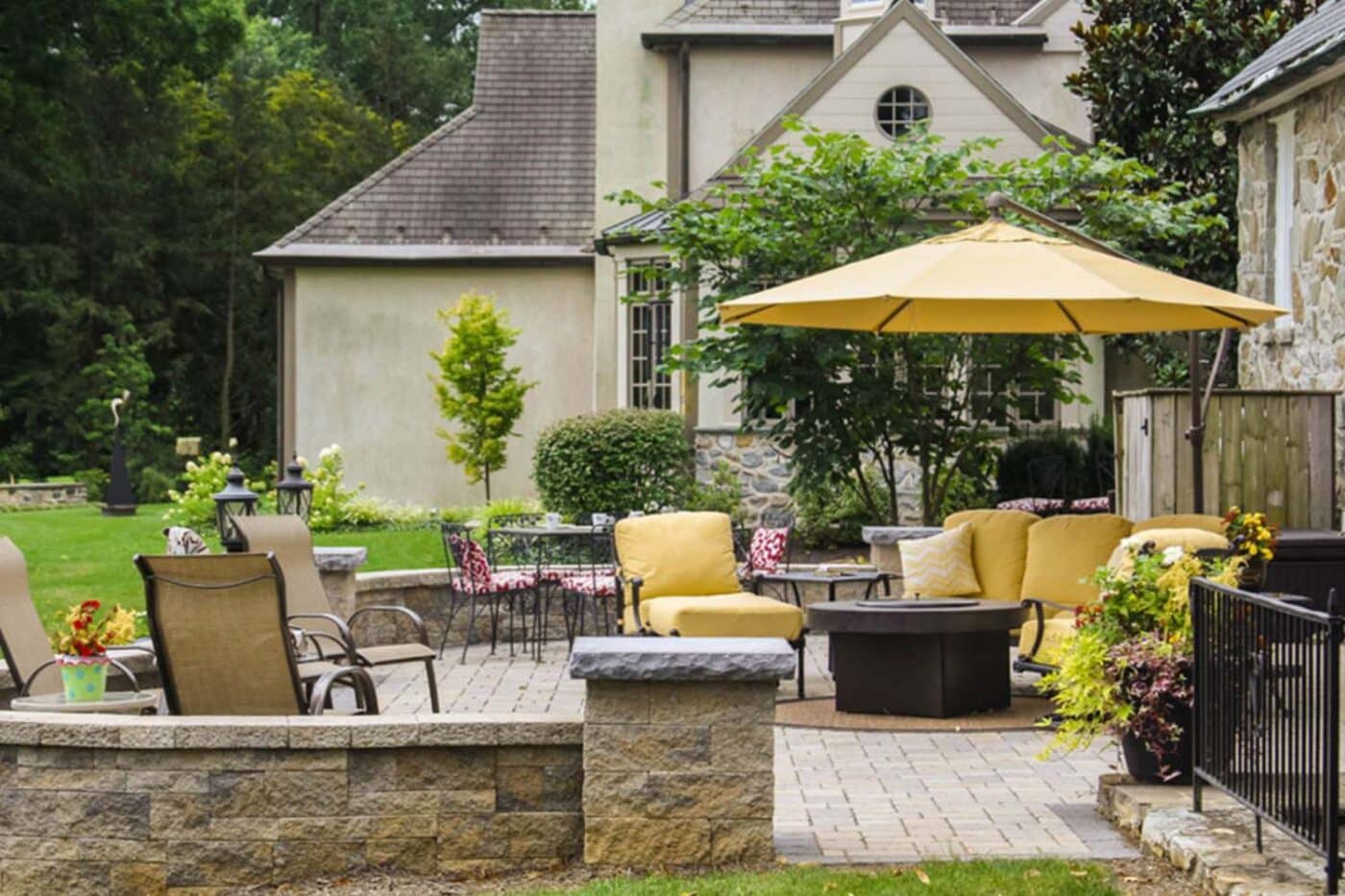 Seating area on patio with firepit and outdoor umbrella