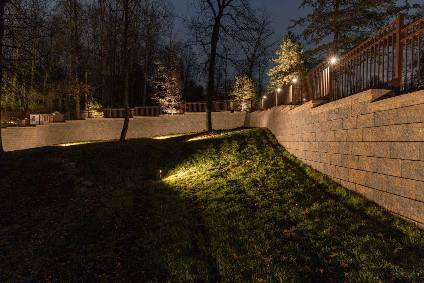Willow Gates Home & Landscape night time image of a retaining wall and lighting setup they installed in Birdsboro PA