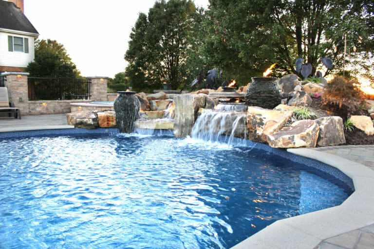 poolside patio with pool and waterfall
