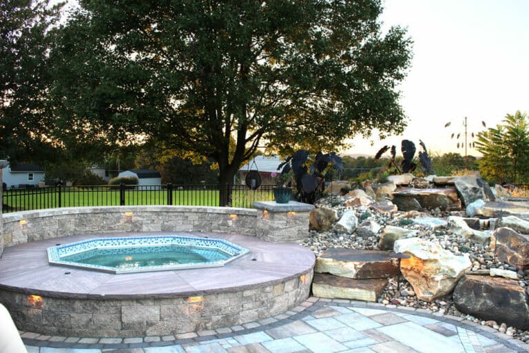 poolside patio with spa and waterfall