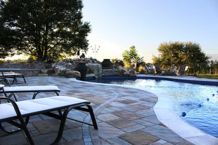 poolside patio with waterfall and fire boulder