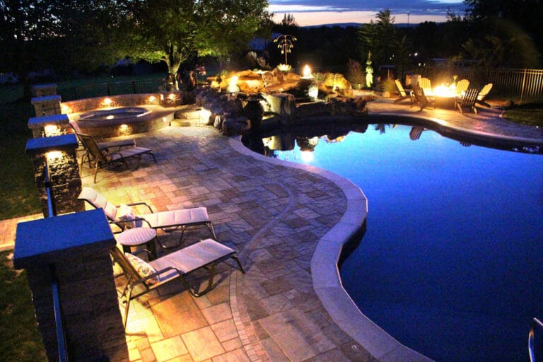poolside patio with waterfall and gate