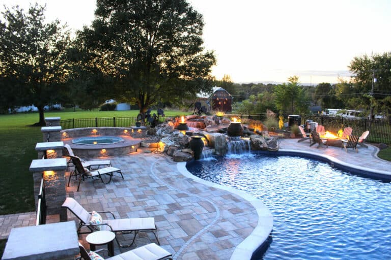 poolside patio with waterfall spa and fire boulder