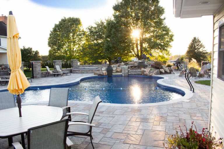 poolside patio with waterfall with sunset