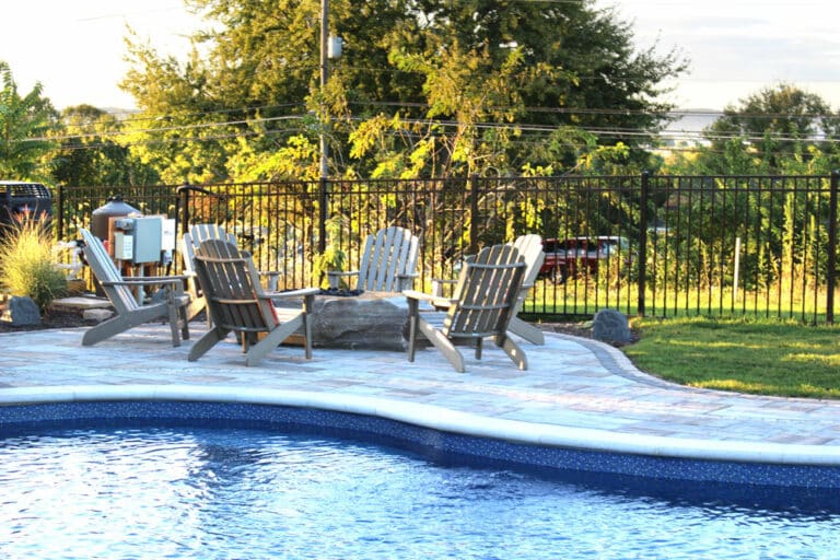 poolside with patio with fire boulder aside