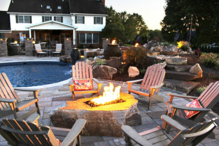 poolside patio with fire boulder lit