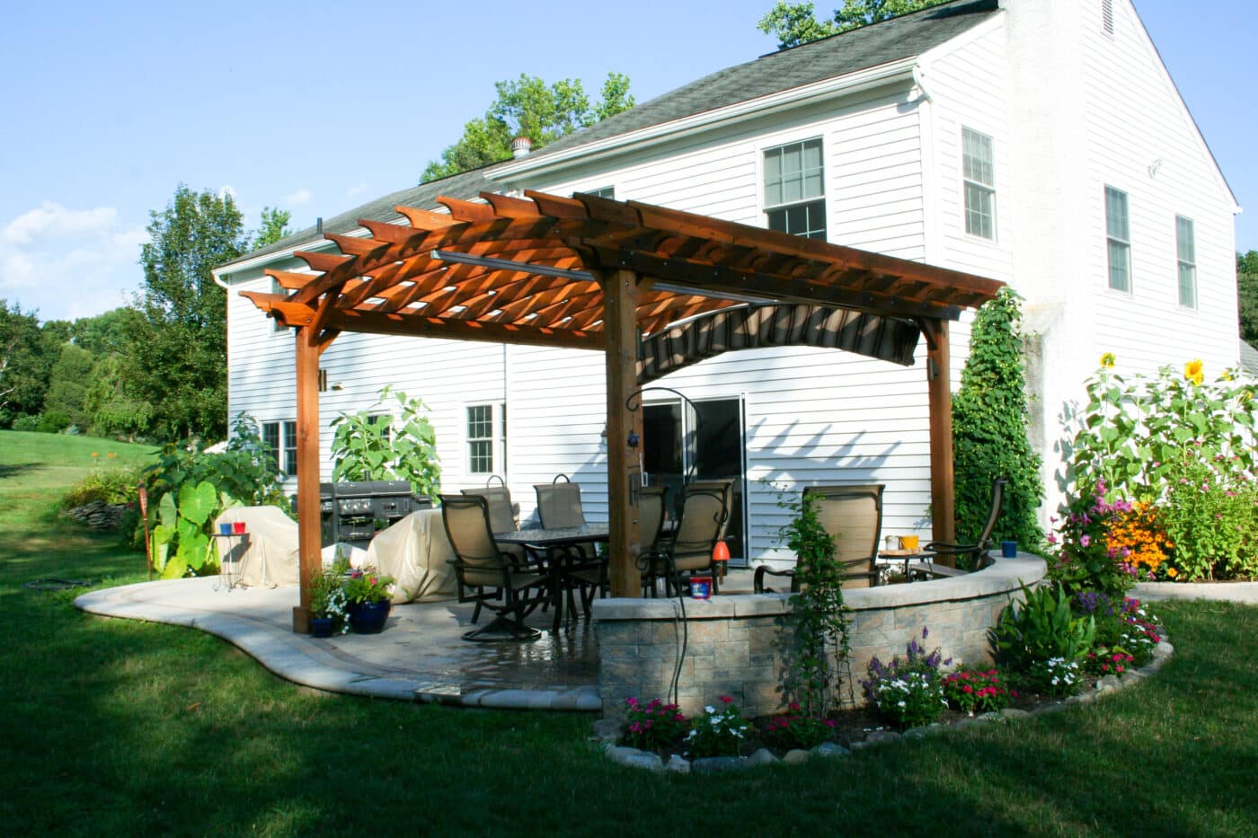 landscaping in King of Prussia with wooden pergola and backyard deck