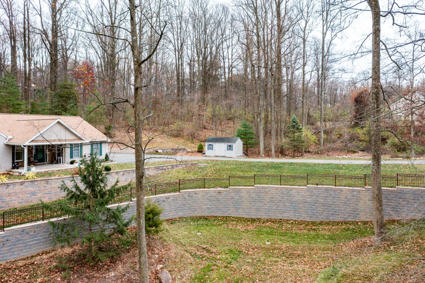 wide angle image of a new retaining wall project by Willow Gates Home & Landscape